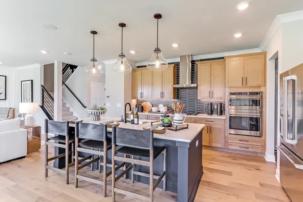 a large kitchen with a table and chairs