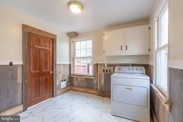 a view of a storage and utility room with washer and dryer