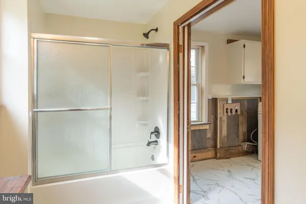 a bathroom with a glass shower door