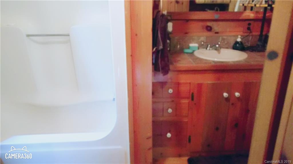 767 Holly Ridge Road Grover, NC 28073 - Photo 18 of 26 a bathroom with a sink and mirror
