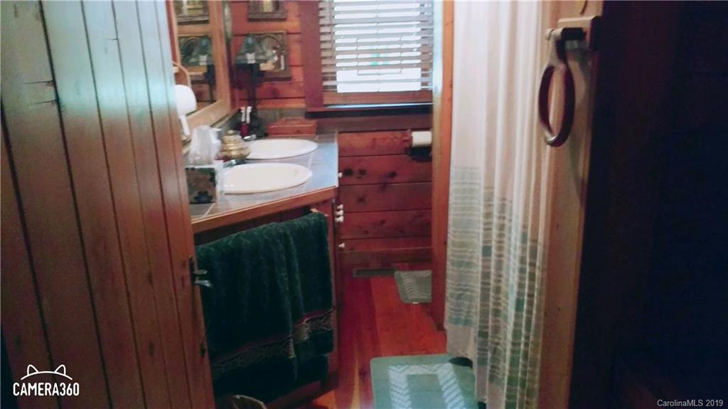 767 Holly Ridge Road Grover, NC 28073 - Photo 19 of 26 a bathroom with a sink and a mirror