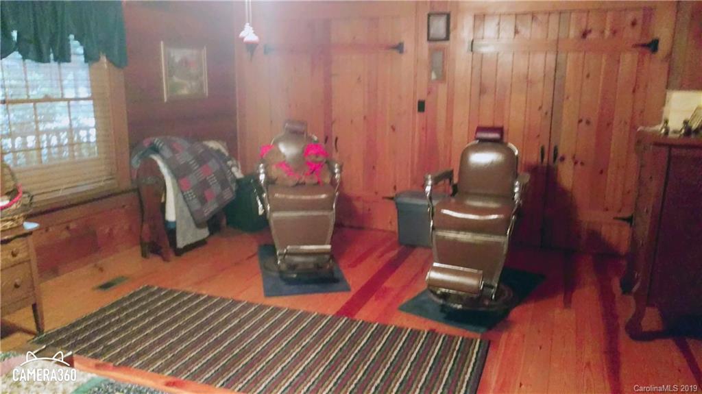 767 Holly Ridge Road Grover, NC 28073 - Photo 22 of 26 a living room with furniture a dining table and a potted plant