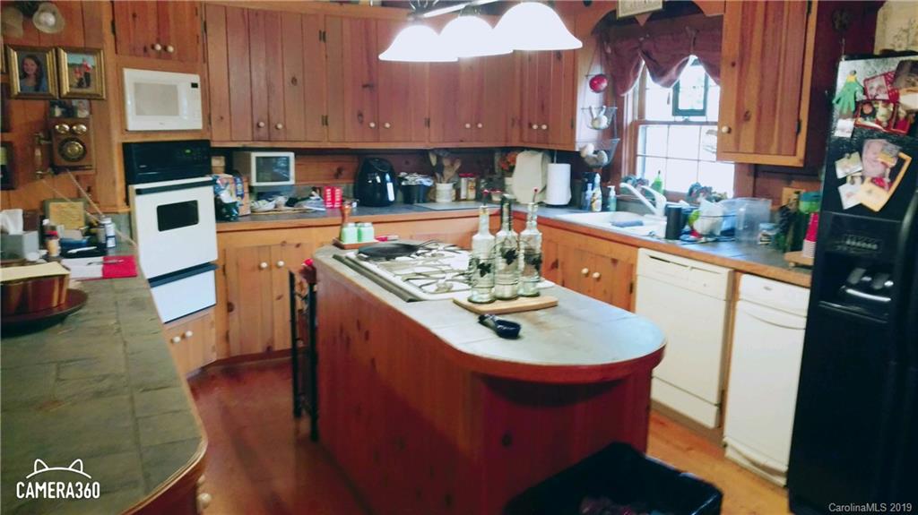 767 Holly Ridge Road Grover, NC 28073 - Photo 24 of 26 a kitchen with stainless steel appliances granite countertop a sink a stove and refrigerator