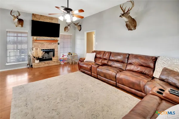 a living room with furniture fireplace and flat screen tv