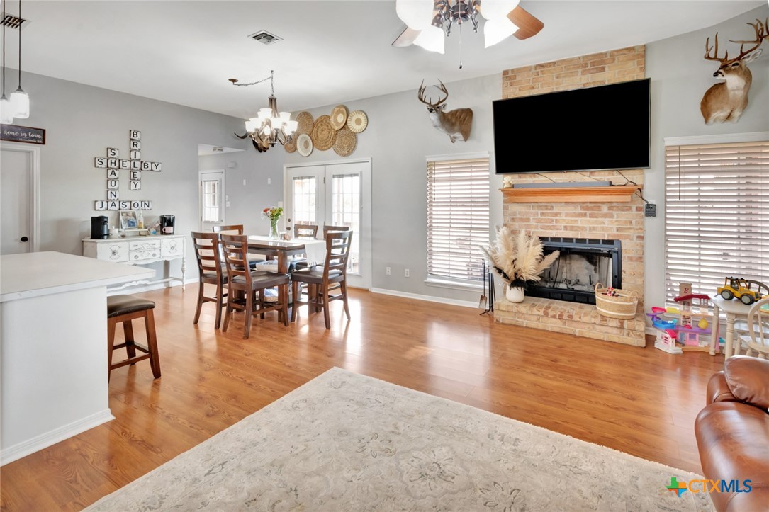 399 Keefe Road Victoria, TX 77905 - Photo 12 of 33 a living room with furniture a flat screen tv and a fireplace
