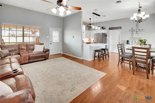 a living room with furniture and a chandelier