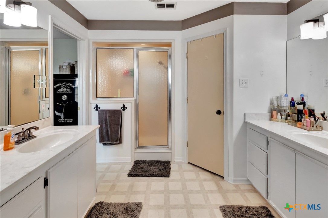 399 Keefe Road Victoria, TX 77905 - Photo 17 of 33 a kitchen with a refrigerator and a sink