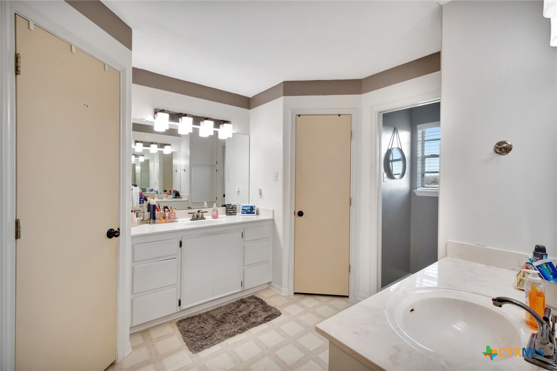 399 Keefe Road Victoria, TX 77905 - Photo 18 of 33 a bathroom with a sink and a mirror