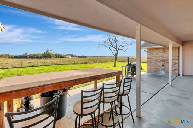 a balcony with table and chairs