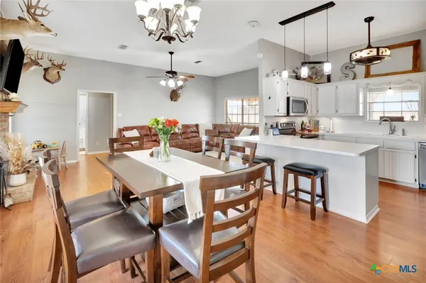 a view of a dining room with furniture wooden floor and chandelier