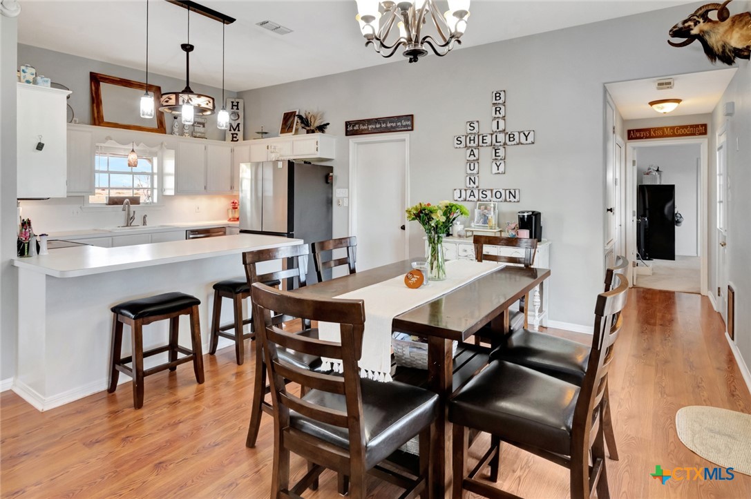 399 Keefe Road Victoria, TX 77905 - Photo 9 of 33 a view of a dining room with furniture and chandelier