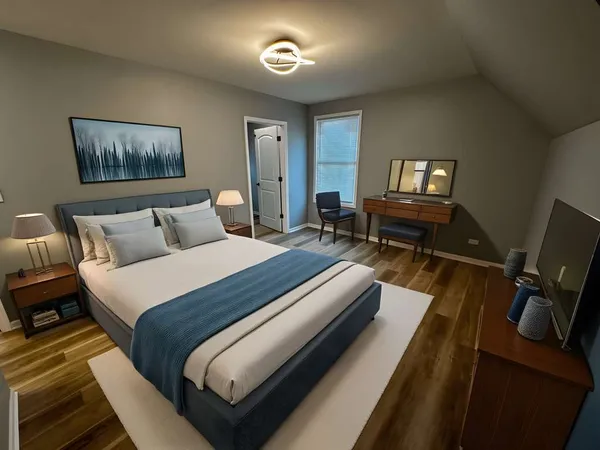 a bedroom with a bed and a potted plant