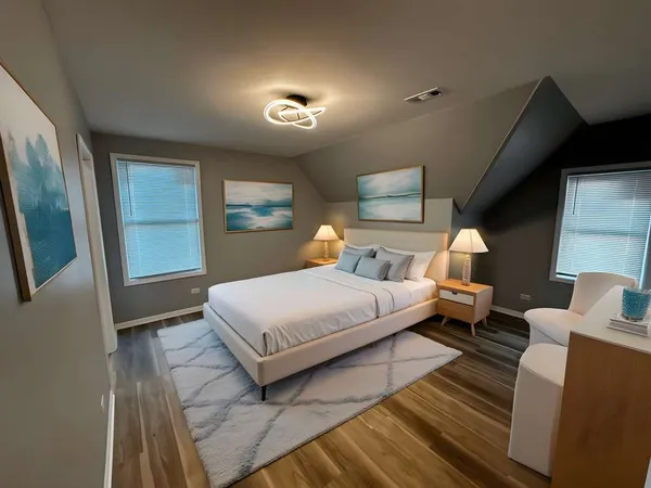 a bedroom with a bed and a potted plant