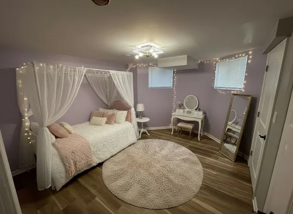 a bathroom with a double vanity sink a mirror and a bathtub