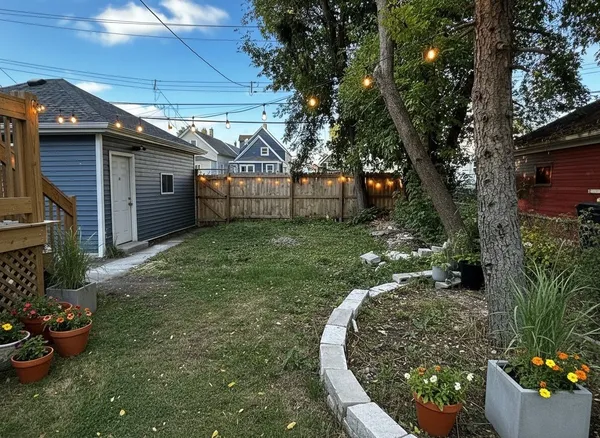 a view of a house with backyard sitting area and garden