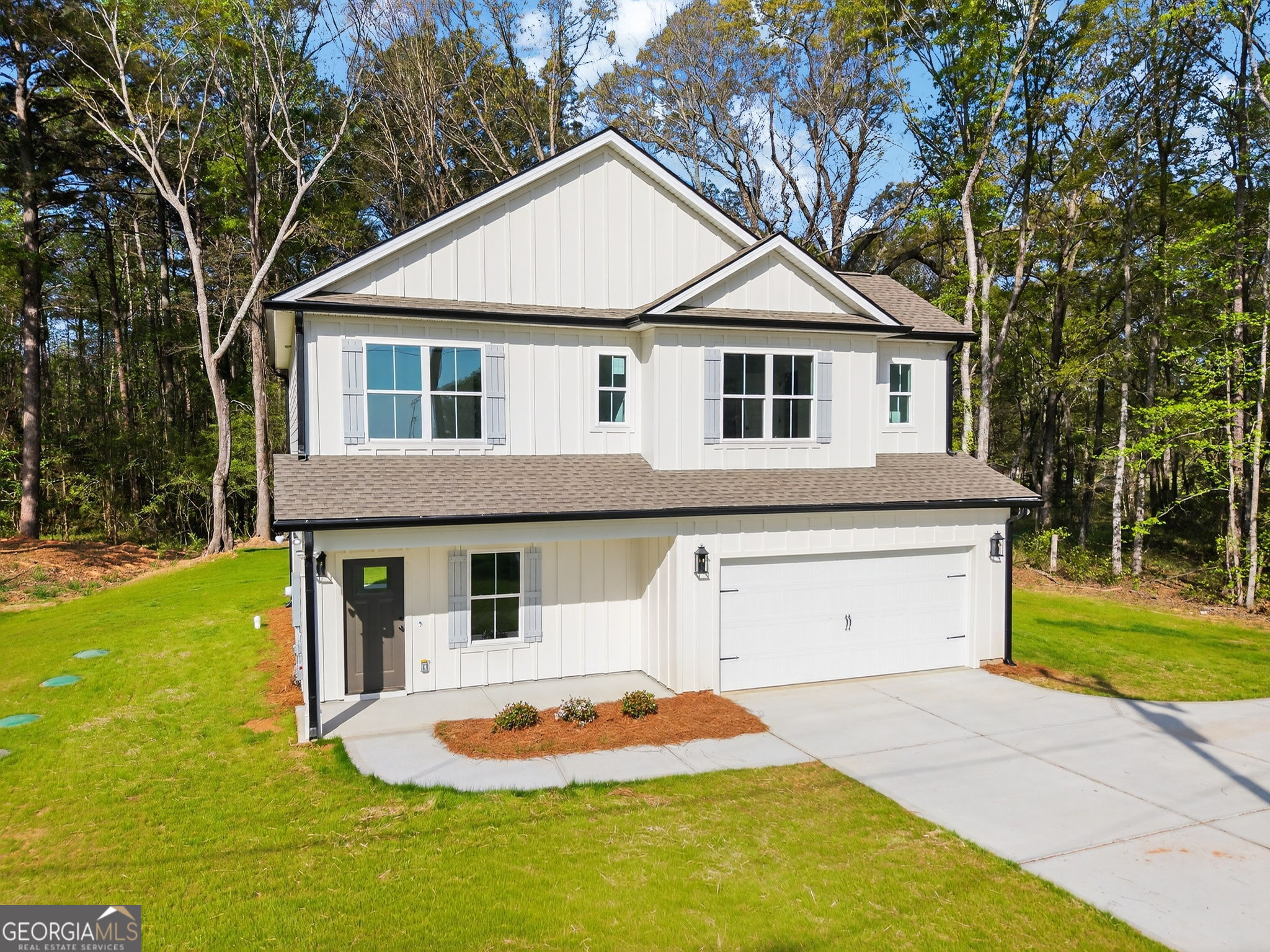 1229 Chappell Mill Road Jackson, GA 30233 - Photo 2 of 55 a front view of a house with a garden