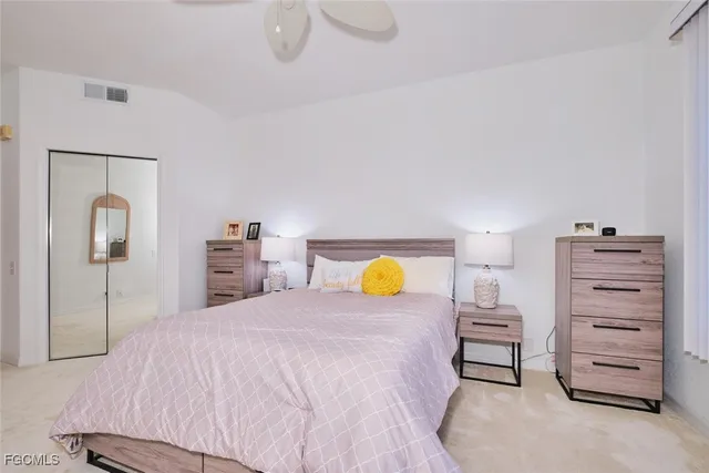 a bedroom with a bed and a mirror