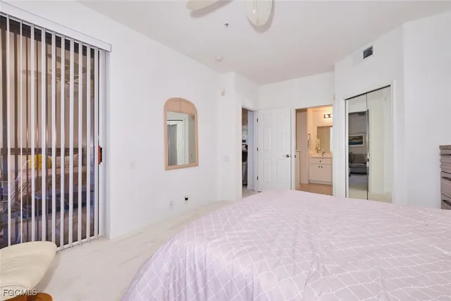a view of a bedroom with a dresser and mirror