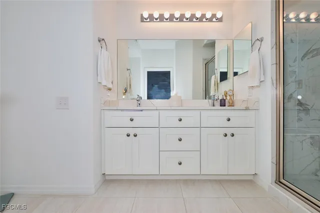 a bathroom with a granite countertop sink a toilet and a mirror