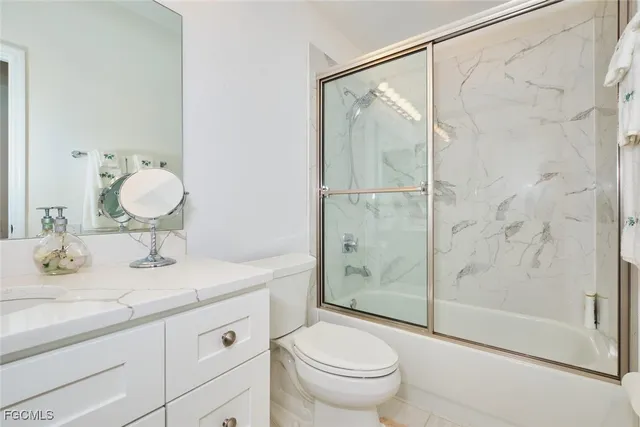 a bathroom with a sink vanity and toilet