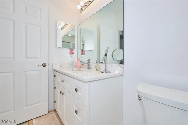 a view of a house with a yard and a large tree