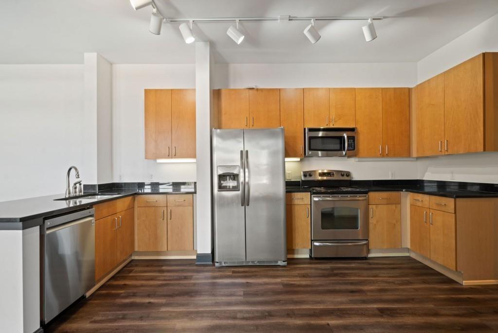 5300 Peachtree Road, Unit 3507 Atlanta, GA 30341 - Photo 11 of 32 a kitchen with stainless steel appliances a refrigerator sink and microwave