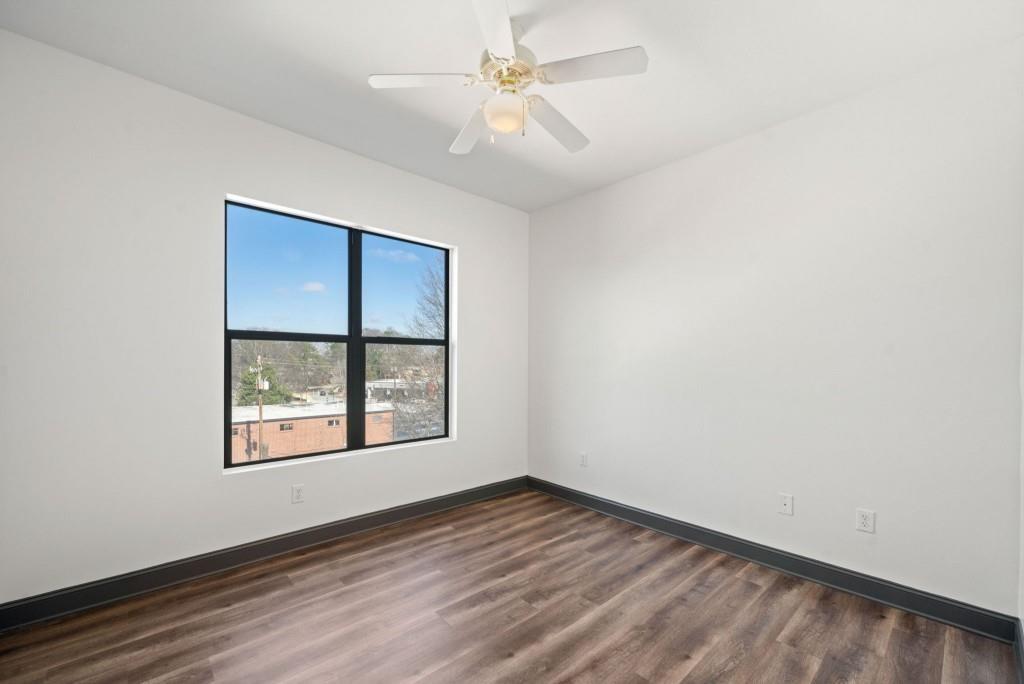 5300 Peachtree Road, Unit 3507 Atlanta, GA 30341 - Photo 23 of 32 an empty room with windows and ceiling fan