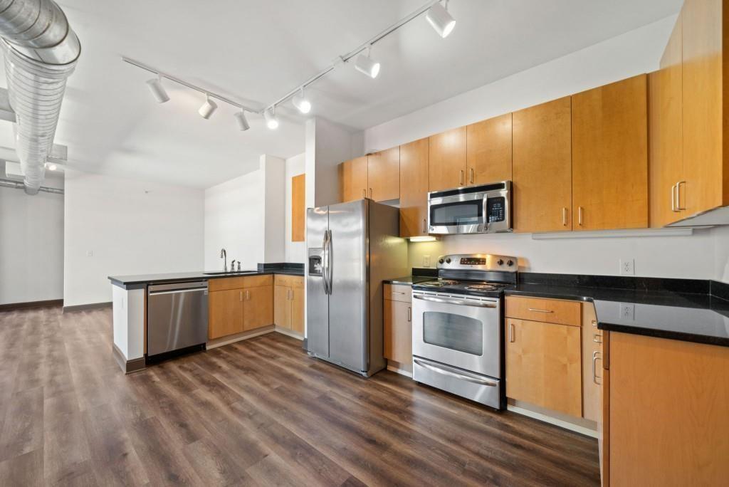 5300 Peachtree Road, Unit 3507 Atlanta, GA 30341 - Photo 8 of 32 a kitchen with granite countertop a refrigerator and a stove top oven