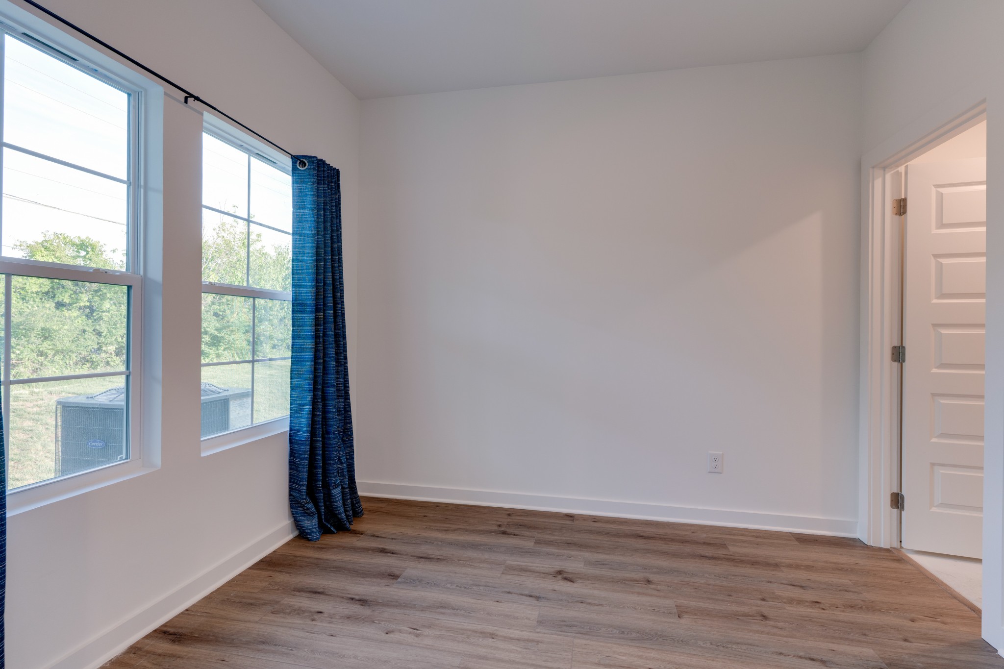 1573 Elliott Williams Way Gallatin, TN 37066 - Photo 11 of 32 a view of an empty room with wooden floor and a window