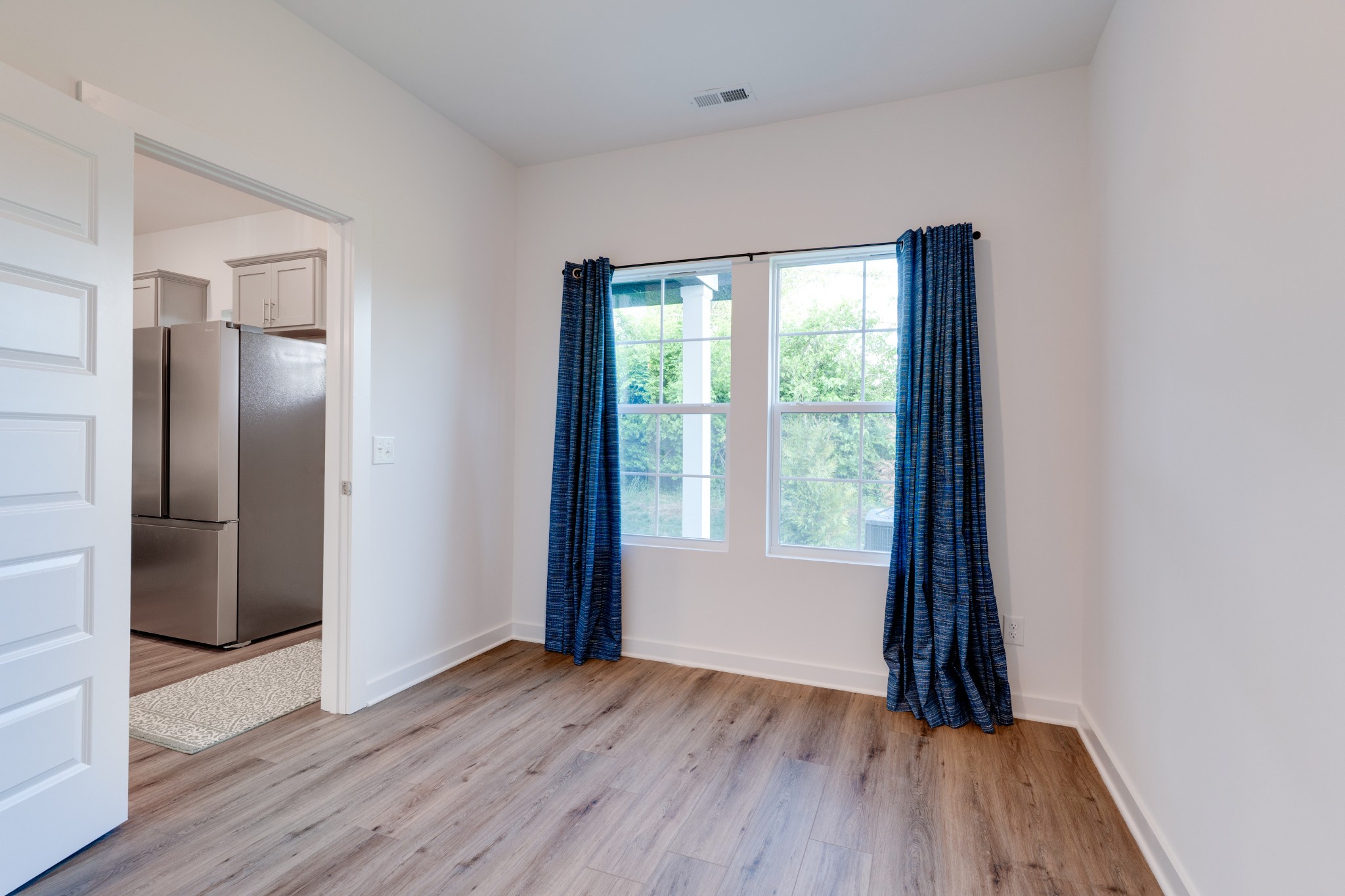 1573 Elliott Williams Way Gallatin, TN 37066 - Photo 12 of 32 a view of an empty room with wooden floor and a window