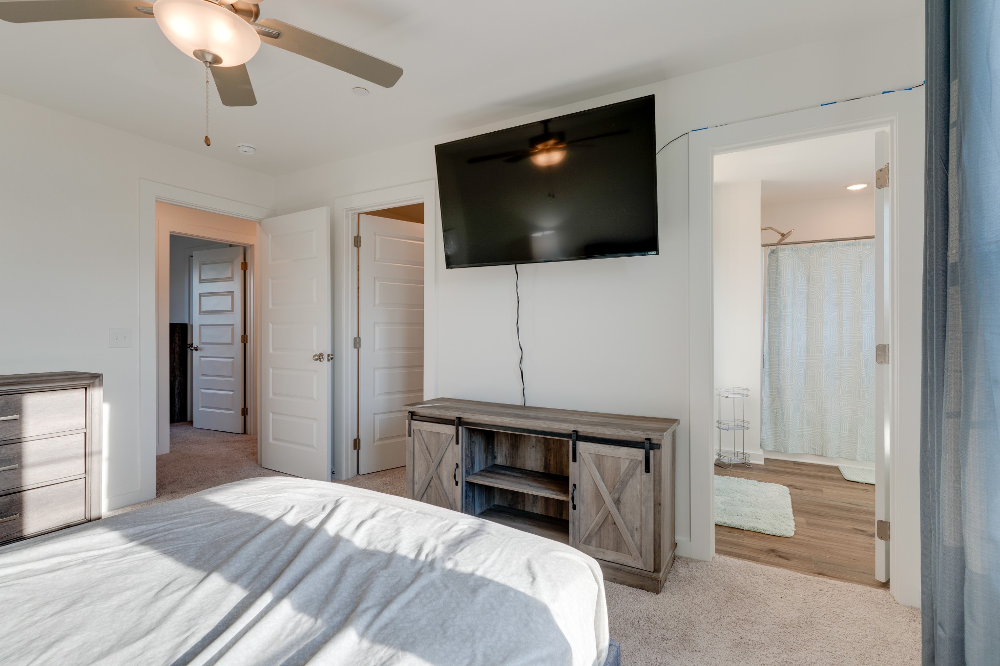 1573 Elliott Williams Way Gallatin, TN 37066 - Photo 21 of 32 a bedroom with a bed and a flat screen tv