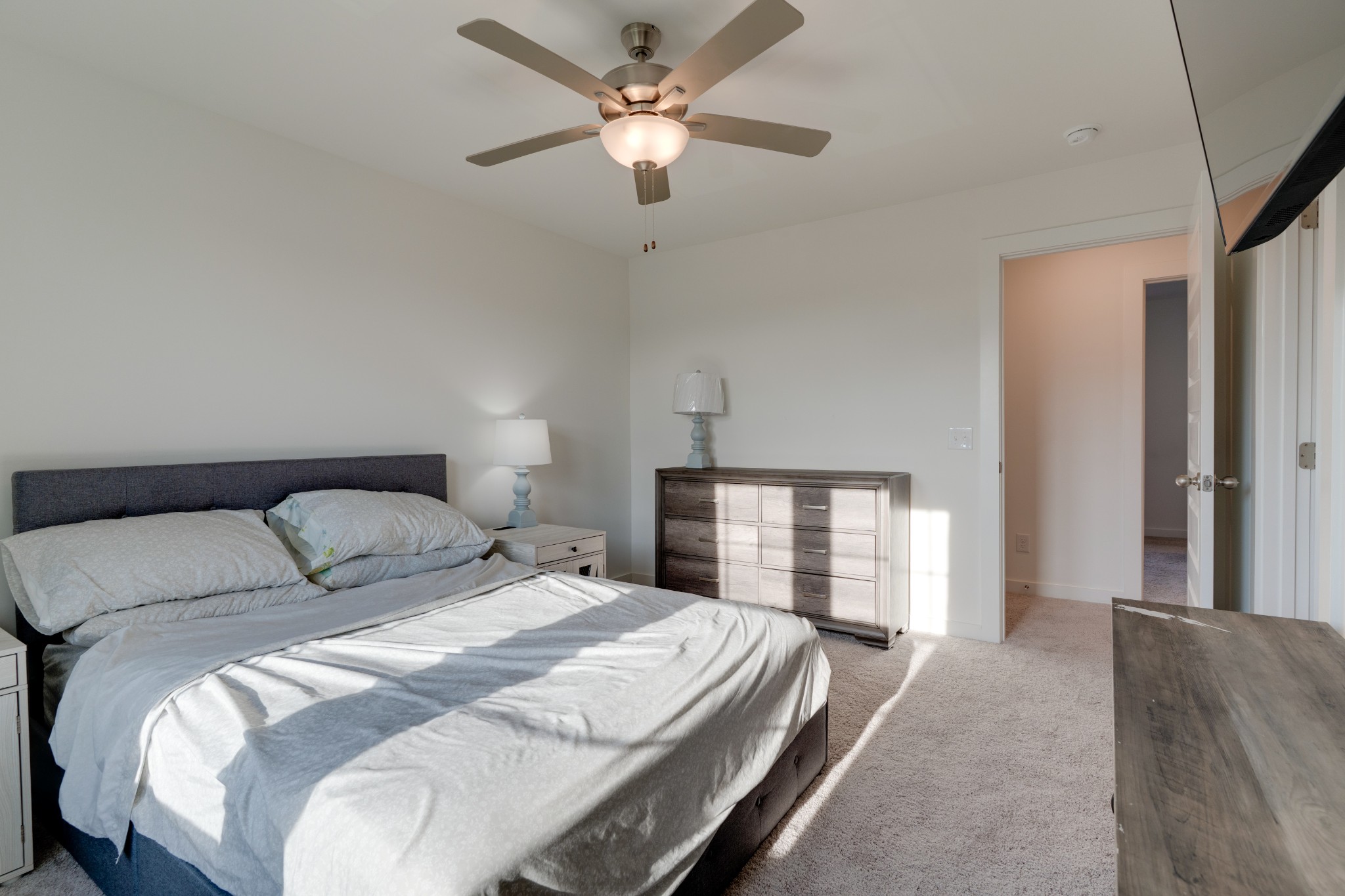 1573 Elliott Williams Way Gallatin, TN 37066 - Photo 22 of 32 a bedroom with a bed and a chandelier