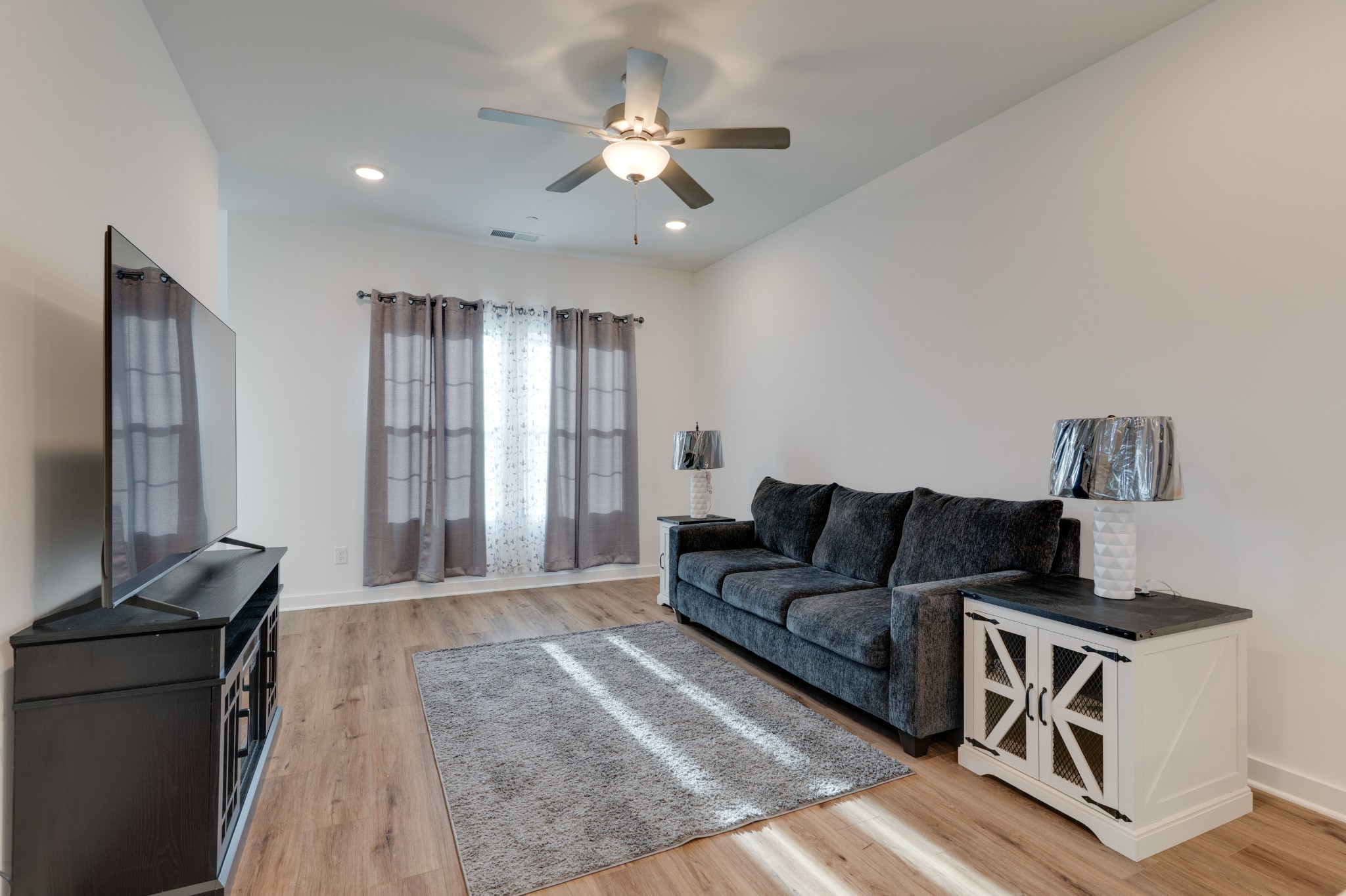 1573 Elliott Williams Way Gallatin, TN 37066 - Photo 6 of 32 a living room with furniture and a flat screen tv