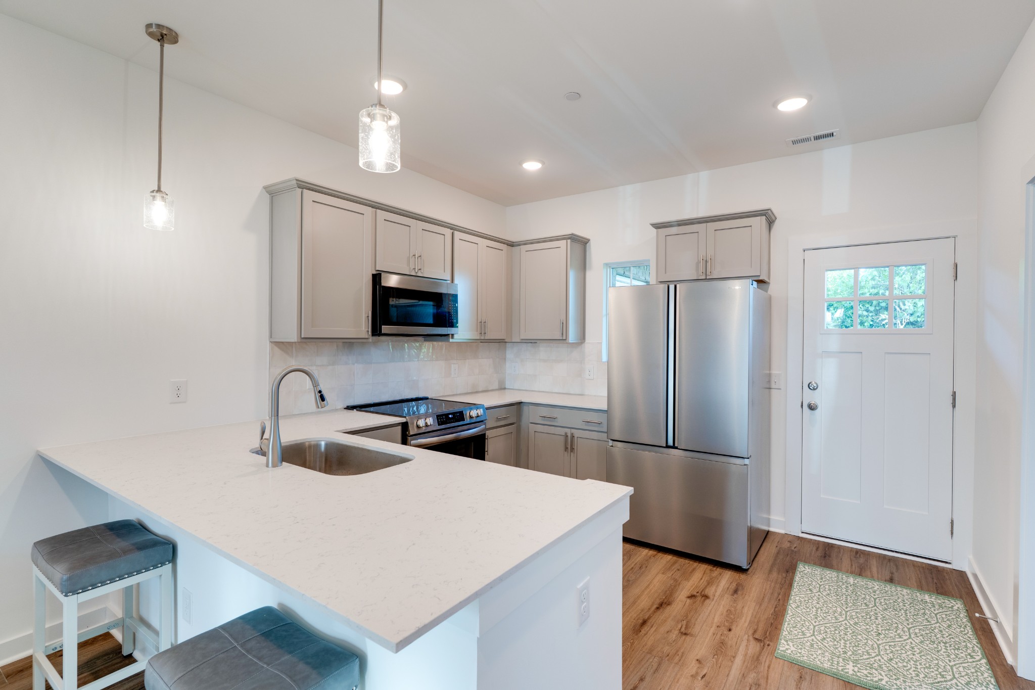 1573 Elliott Williams Way Gallatin, TN 37066 - Photo 8 of 32 a kitchen with a refrigerator a sink and a microwave