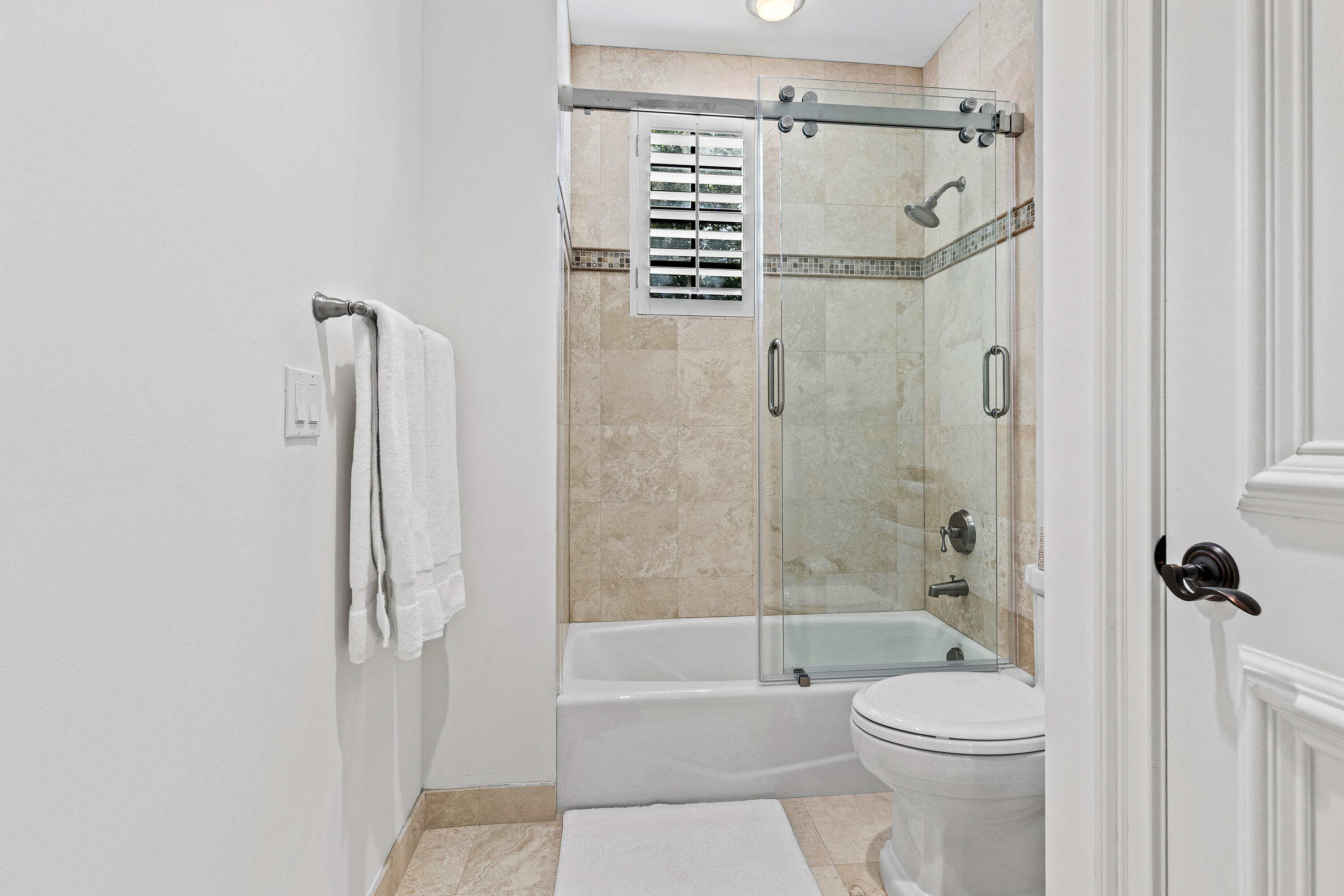 110 Gleason Street, Unit 203 Delray Beach, FL 33483 - Photo 19 of 25 a bathroom with a shower a toilet and a shower