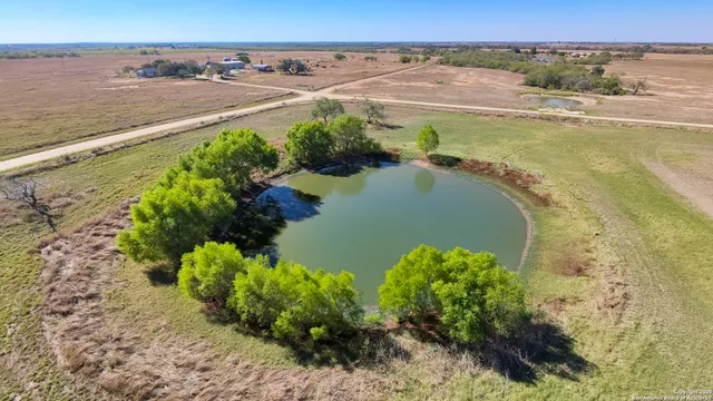a view of a swimming pool with a yard in back