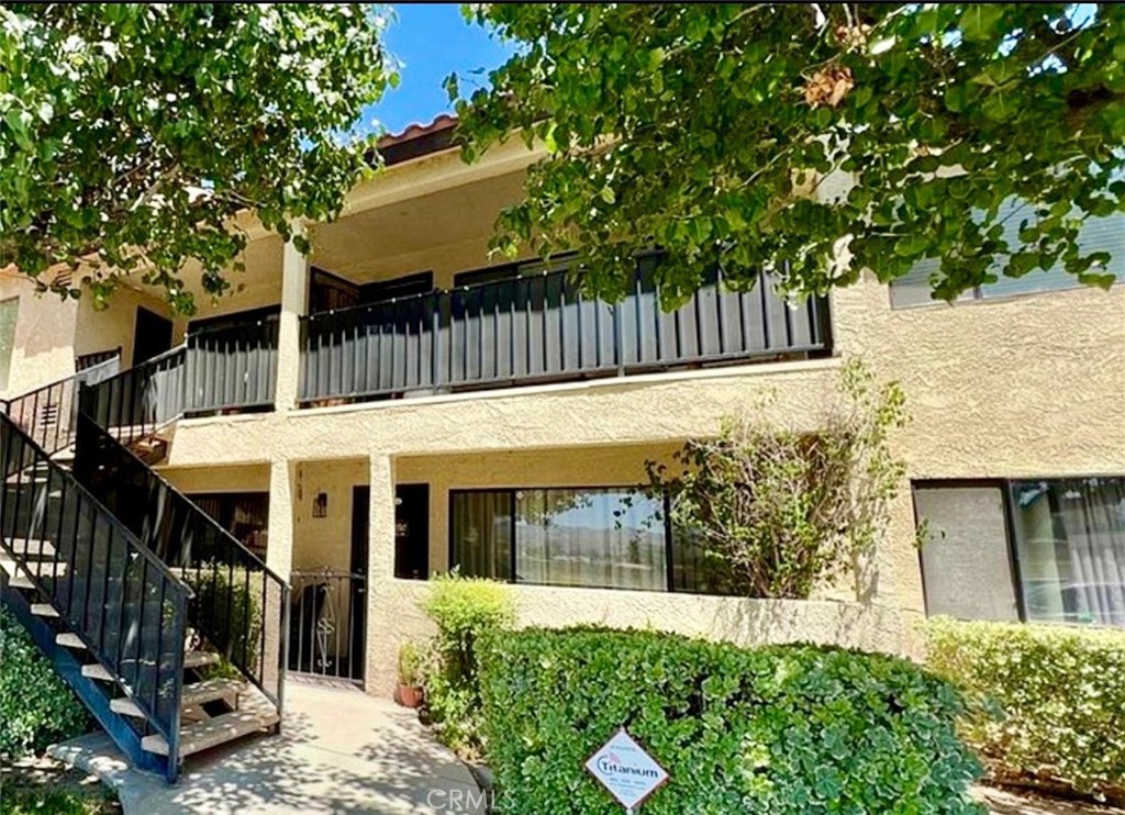 43142 Andrade Avenue, Unit S Hemet, CA 92544 - Photo 2 of 3 a view of a house with a yard and wooden fence