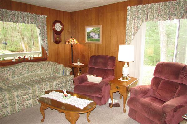60 Farquhar Road Sturbridge, MA 01566 - Photo 11 of 30 a living room with furniture a table and a large window