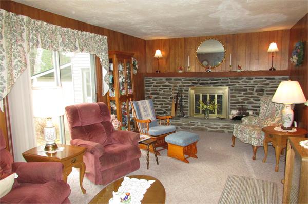 60 Farquhar Road Sturbridge, MA 01566 - Photo 13 of 30 a living room with furniture a lamp and a fireplace