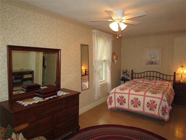 60 Farquhar Road Sturbridge, MA 01566 - Photo 22 of 30 a bedroom with a bed and a chandelier