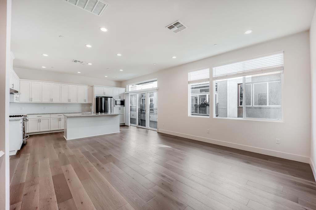 183 Nexus Loop San Jose, CA 95110 - Photo 11 of 33 a view of large kitchen with a sink wooden floor and a kitchen