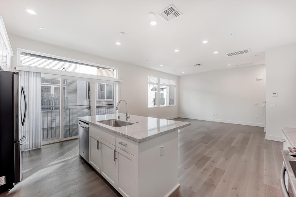 183 Nexus Loop San Jose, CA 95110 - Photo 17 of 33 a bathroom with a granite countertop sink a toilet a mirror and shower
