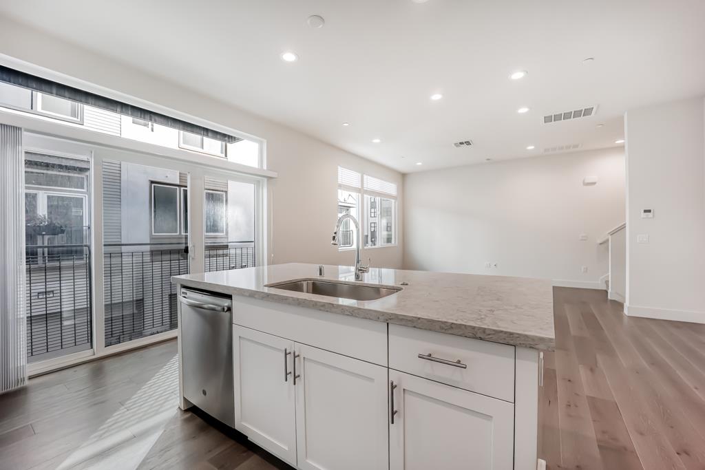 183 Nexus Loop San Jose, CA 95110 - Photo 21 of 33 a hallway with sink and mirror