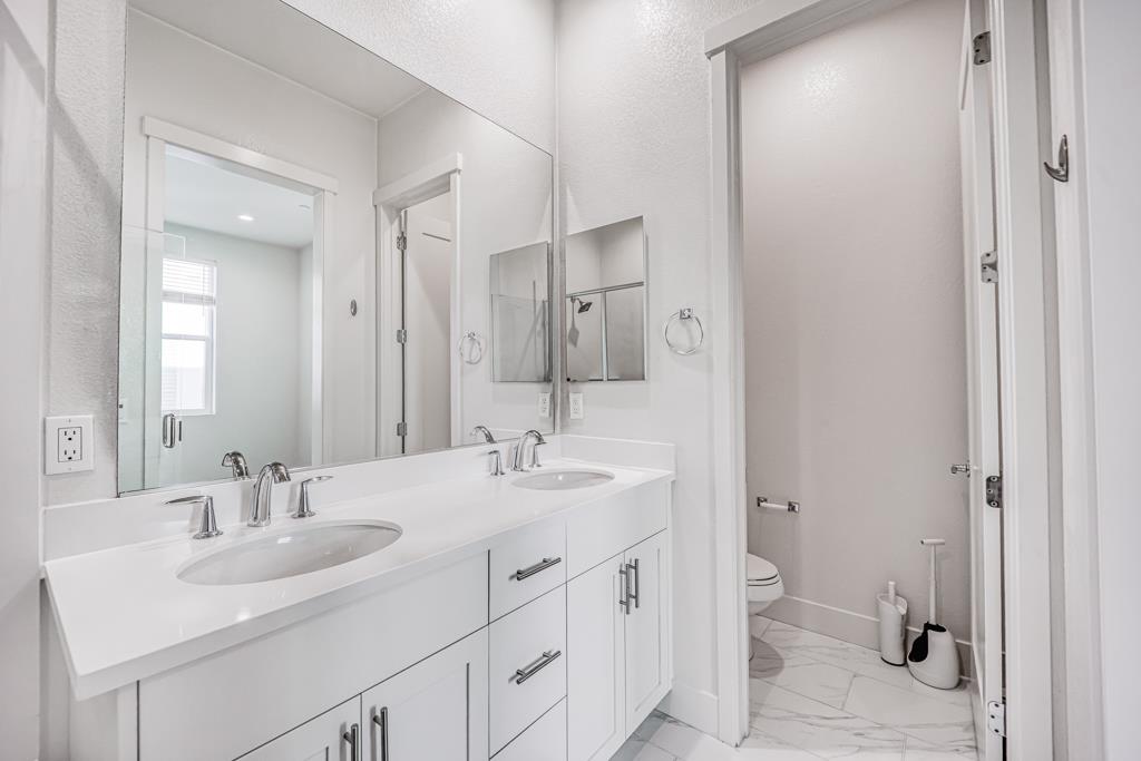 183 Nexus Loop San Jose, CA 95110 - Photo 25 of 33 a bathroom with a sink double vanity and a mirror