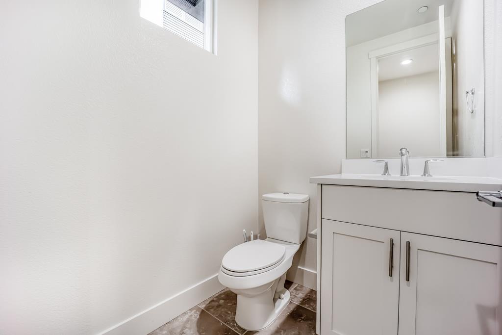 183 Nexus Loop San Jose, CA 95110 - Photo 30 of 33 a bathroom with a toilet sink vanity and mirror