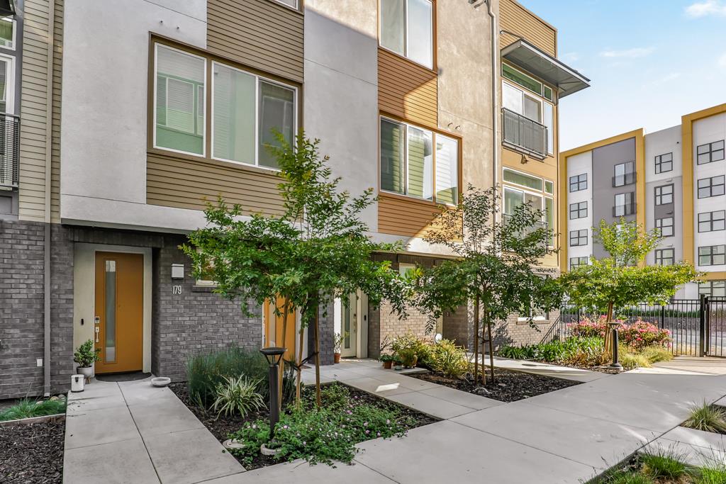 183 Nexus Loop San Jose, CA 95110 - Photo 4 of 33 a front view of a house with plants