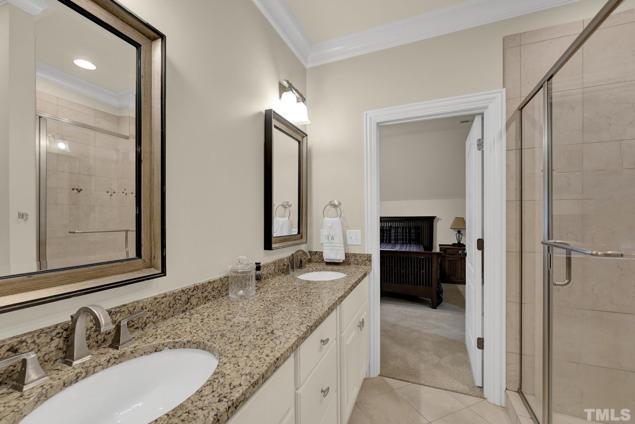 2229 Coley Forest Place Raleigh, NC 27607 - Photo 23 of 44 a bathroom with a granite countertop double vanity sink and a mirror