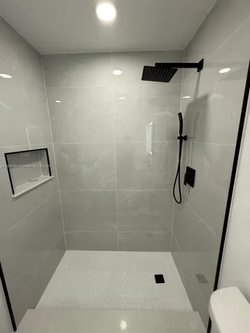 a bathroom with a shower and a bathtub