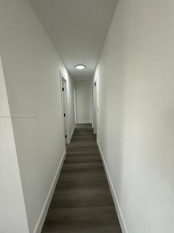 a view of a hallway with stairs