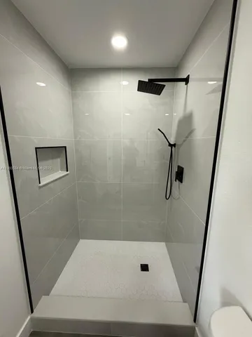 a bathroom with a shower and a toilet